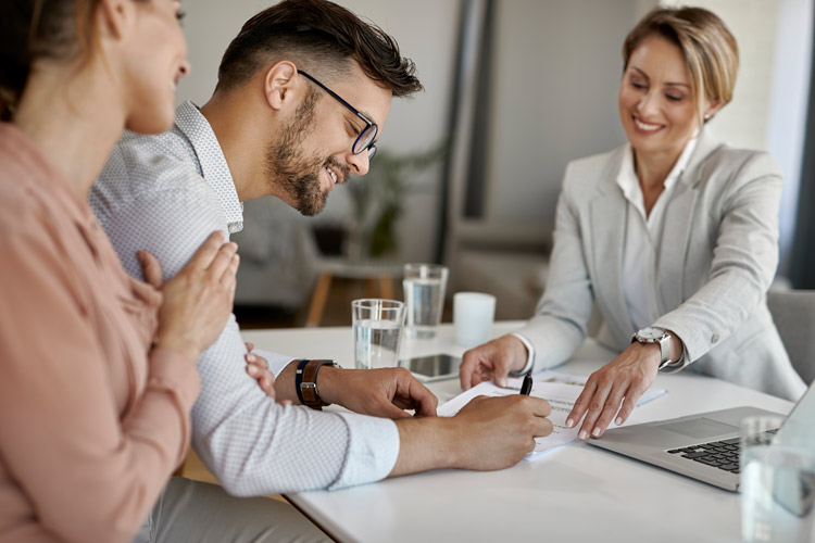 A couple working with a lender to find the best funding option