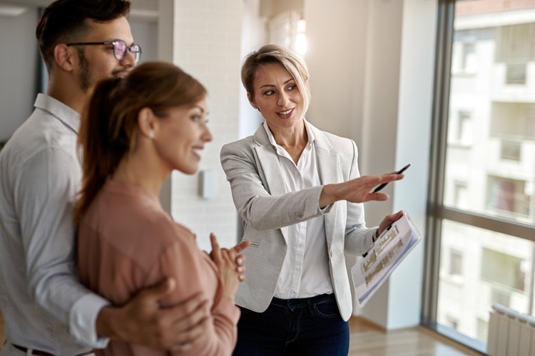 A real estate agent showing buyers a property