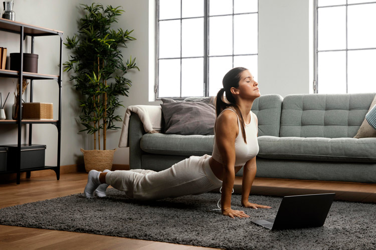 Woman doing yoga in her living room