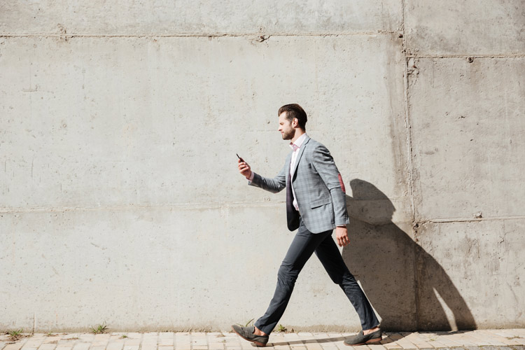 Man in business casual clothes walking to meeting