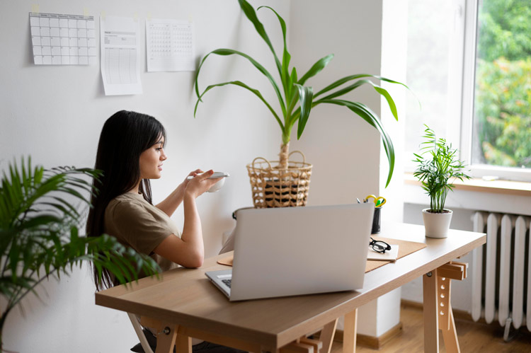 A woman sitting in a home office with great natural lighting