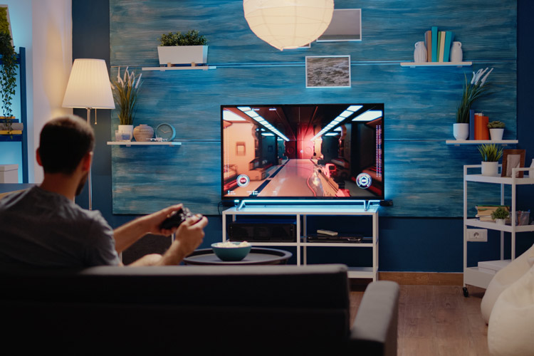A person playing a video game in their game room.
