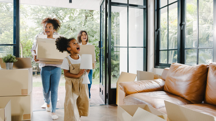 happy family walking into new home