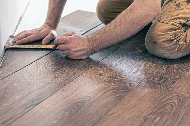 Person working on a hardwood floor