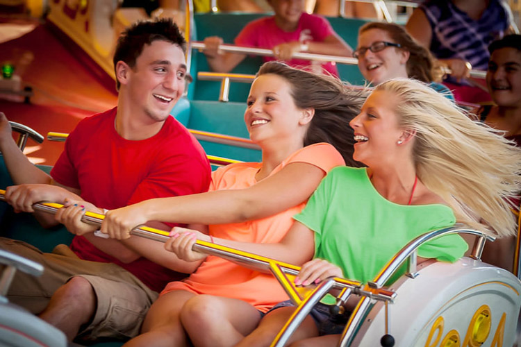 Three people riding on a ride at Waldameer