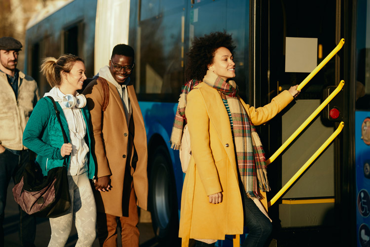 A woman stepping onto a bus