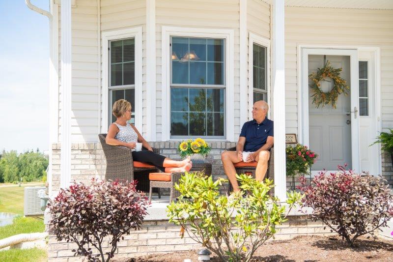 Two people sitting on porch